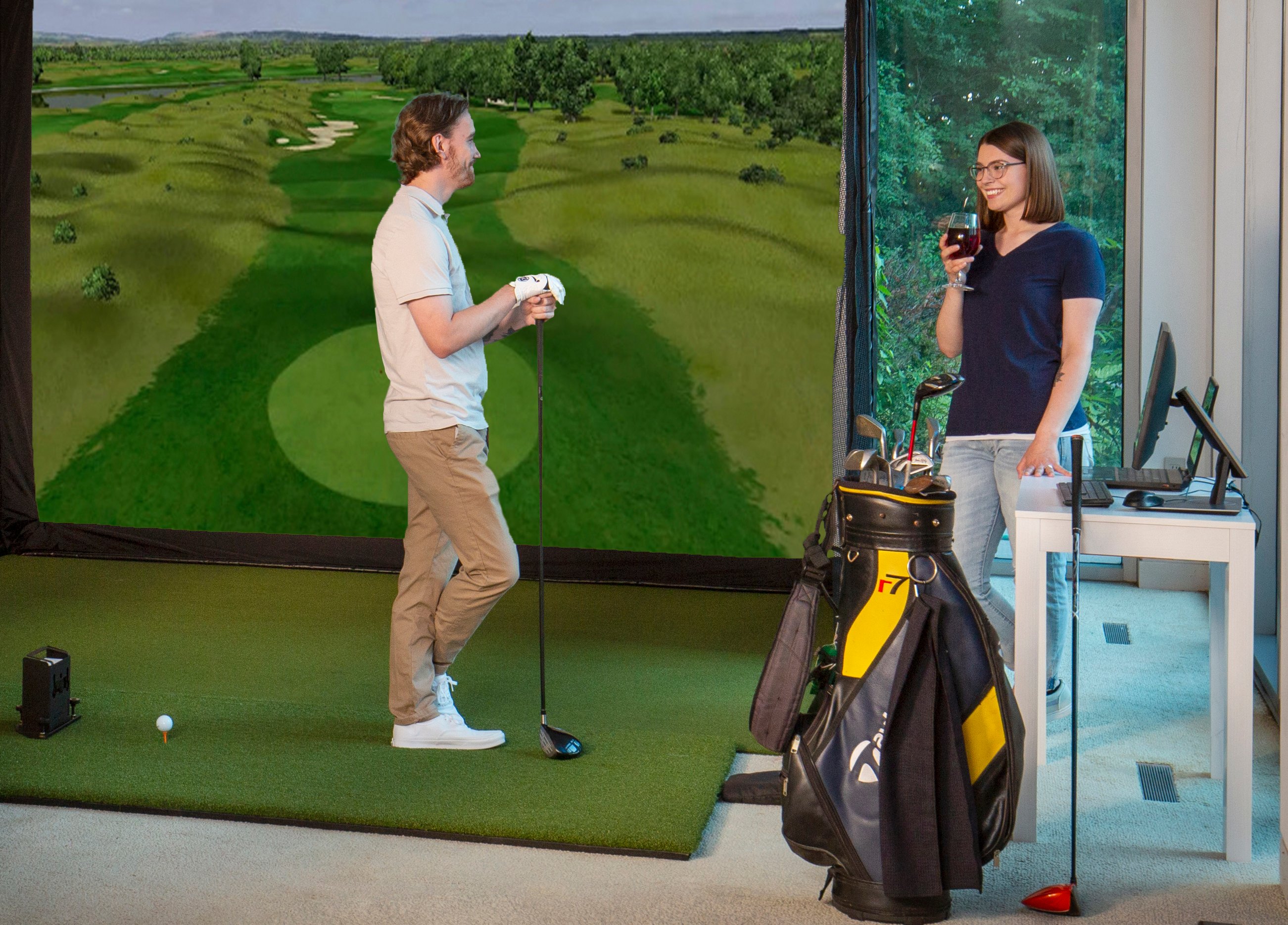 Man and woman talking about a golf simulator