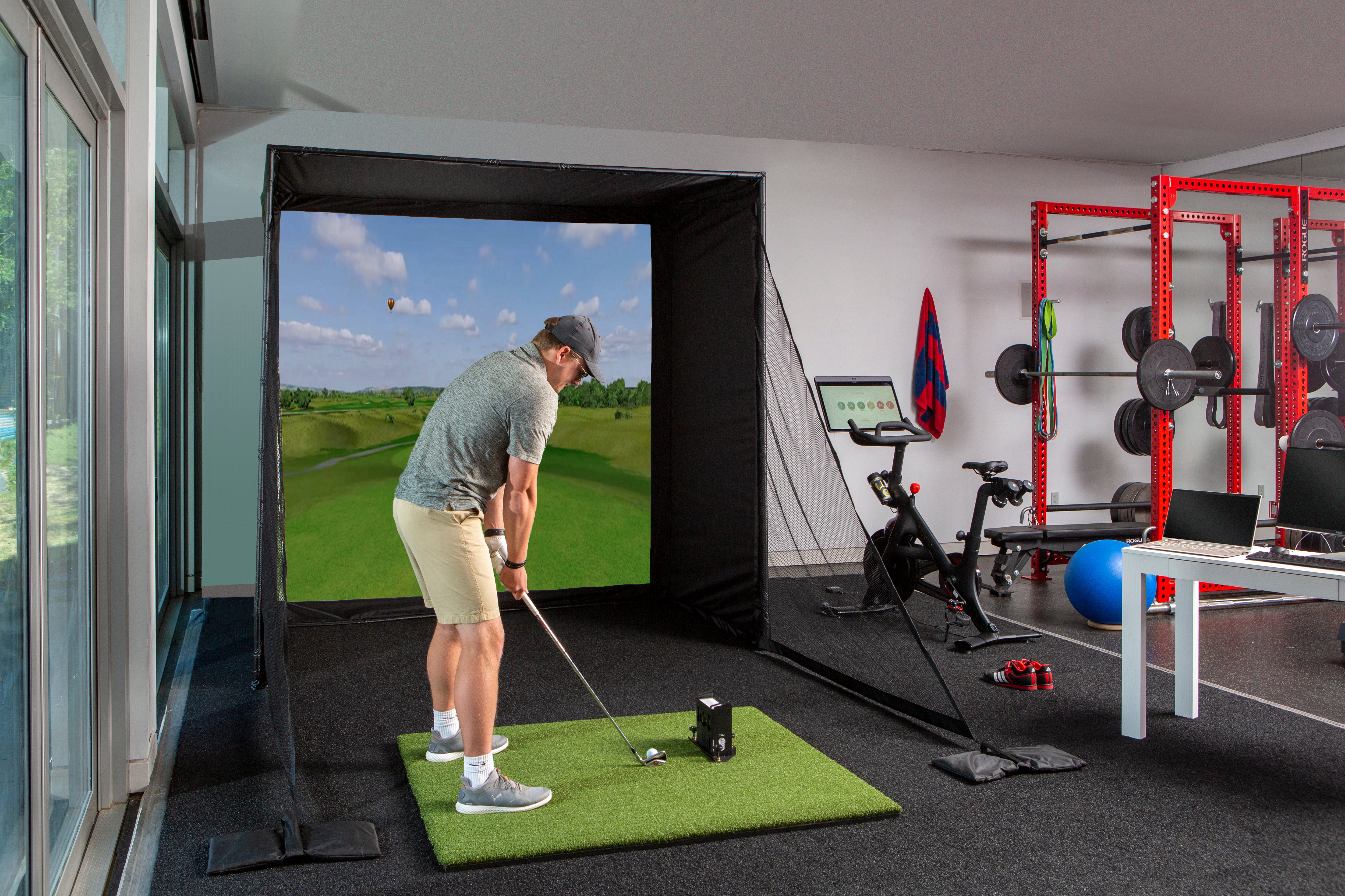 Indoor golf simulator in home workout gym
