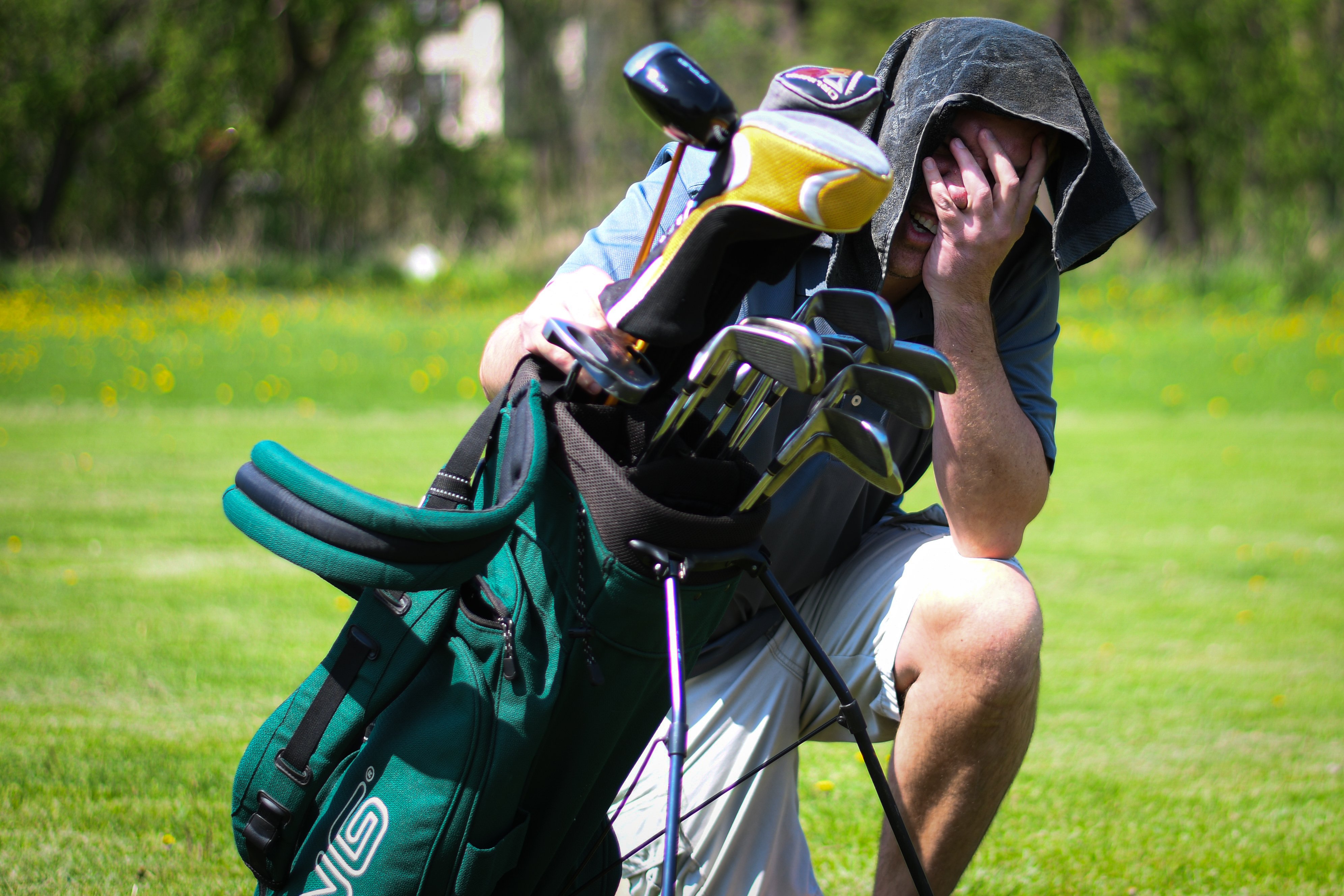 Golfer overheating with cool towel on head