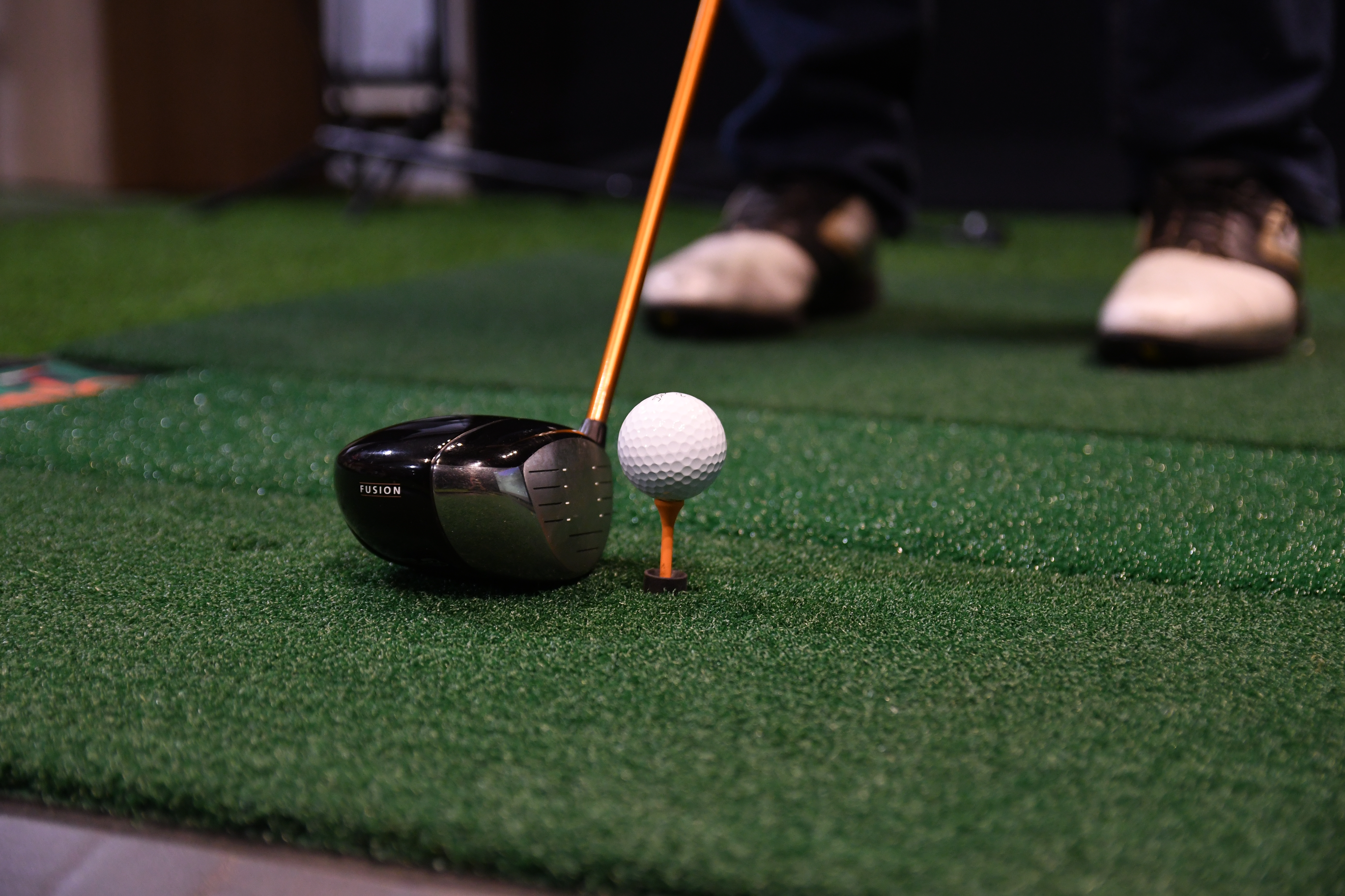 golfer teeing up in a golf simulator